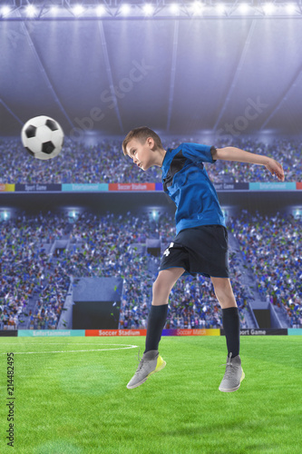 football player hitting the ball with head on a soccer stadium © 27mistral