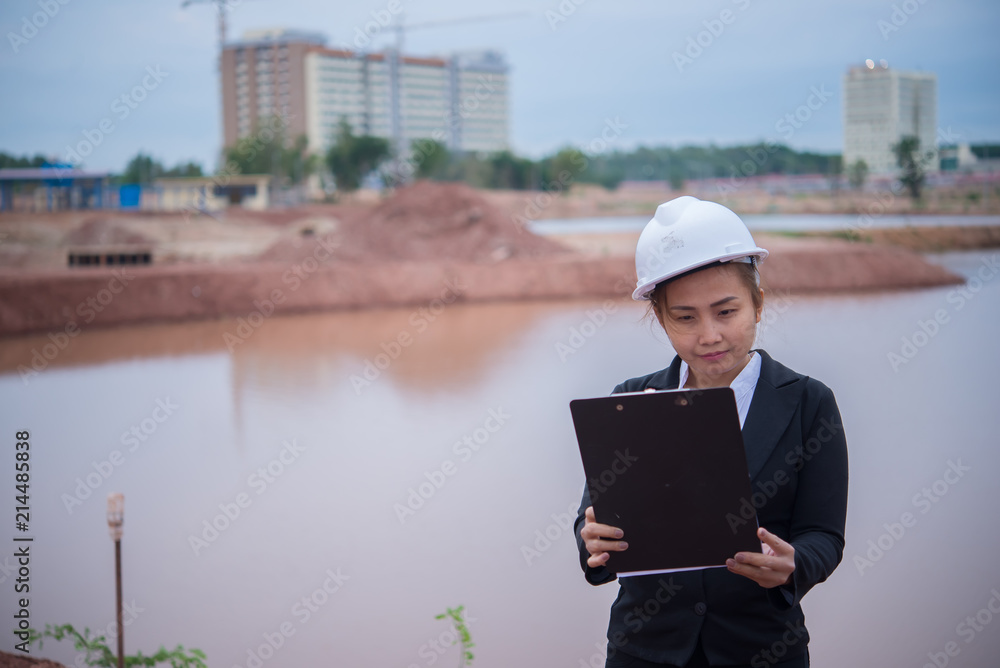 Engineer woman working at site of bridge under construction Engineer woman working at site of bridge under construction