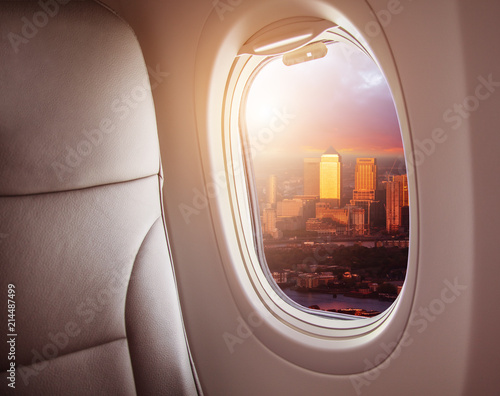 Airplane interior with window view of London city, Europe.