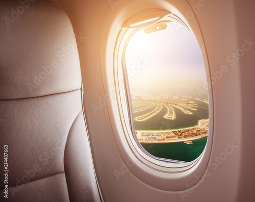 Airplane interior with window view of Dubai city