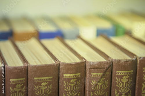 a stack of colorful books on the shelf
