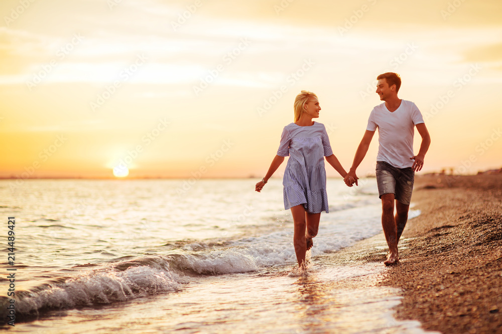 Young happy couple on seashore.
