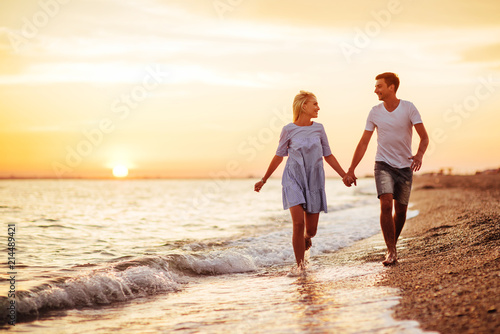 Young happy couple on seashore.