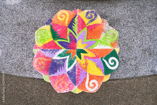The finished rangoli decorated by multi-colored rice on the floor