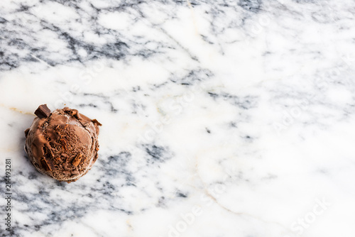 Chocolate ice cream scoops on marble background