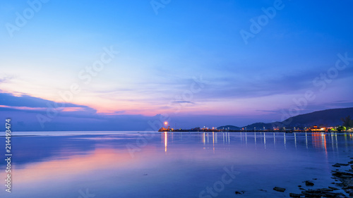 Beautiful natural landscape of the light reflecting the surface at Nathon Pier and boat on colorful sky twilight after sunset over the sea at Ko Samui island, Surat Thani, Thailand, 16:9 widescreen