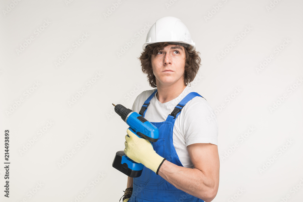 Portrait of handsome builder with skrewdriver on white background Portrait of handsome builder with skrewdriver on white background