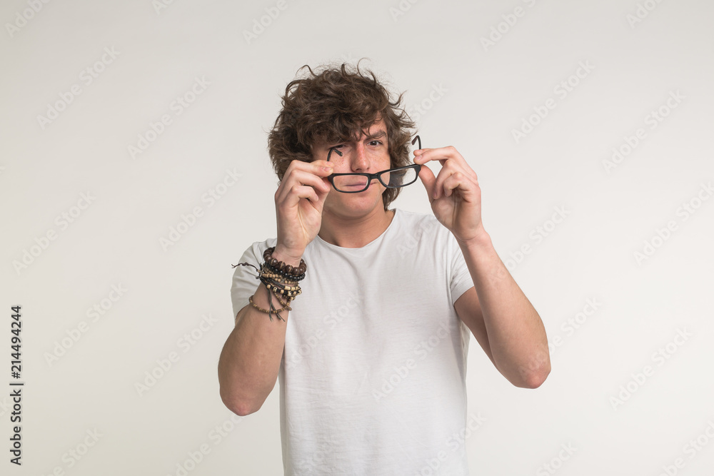 Health, vision problems and people concept - Portrait of student man wearing eye glasses on white background Health, vision problems and people concept - Portrait of student man wearing eye glasses on white background