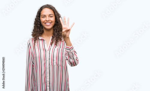 Beautiful young hispanic woman showing and pointing up with fingers number four while smiling confident and happy. © Krakenimages.com