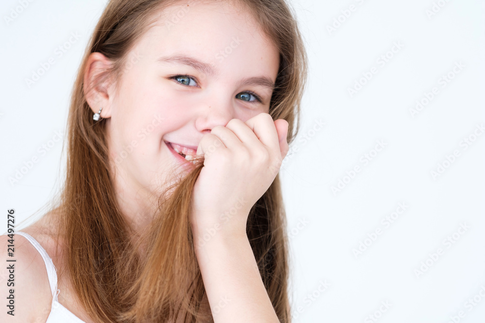 emotion face. playful mischievous smiling child covering her mouth and teeth with hair. little girl portrait on white background. mood feelings personality and facial expression concept emotion face. playful mischievous smiling child covering her mouth and teeth with hair. little girl portrait on white background. mood feelings personality and facial expression concept