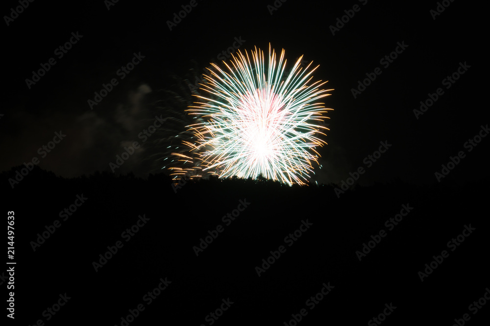 Fototapeta premium Two magic simultaneous fireworks explosions in white color