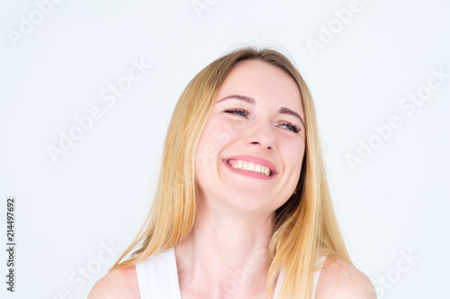 emotion face. very happy joyful thrilled to bits woman with beaming smile. young beautiful blond girl portrait on white background.