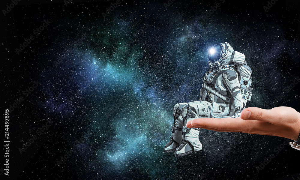 Fototapeta premium Spaceman on finger. Mixed media