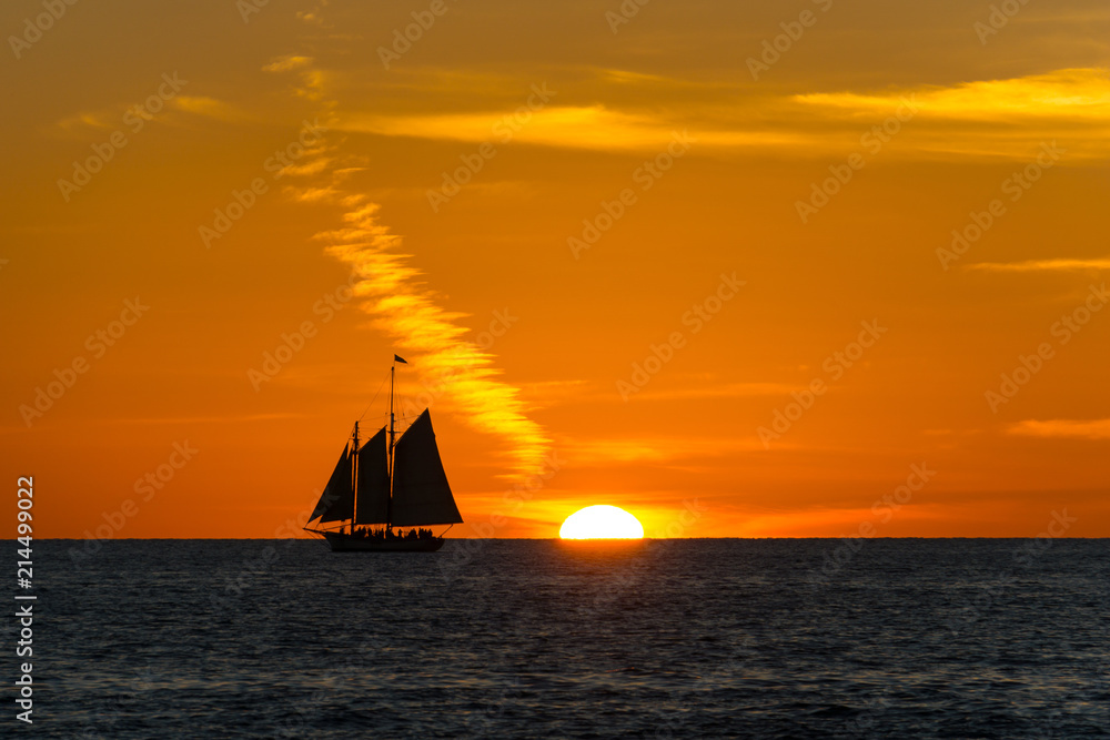USA, Florida, Ancient sailing boat next to fantastic orange sunset