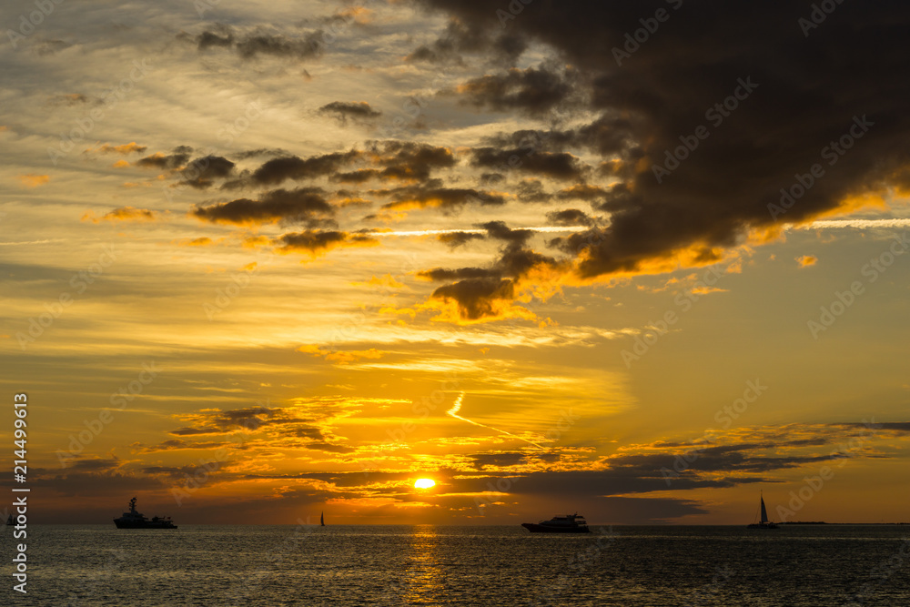 USA, Florida, Dramatic orange sky sunset with some boats on the ocean water USA, Florida, Dramatic orange sky sunset with some boats on the ocean water