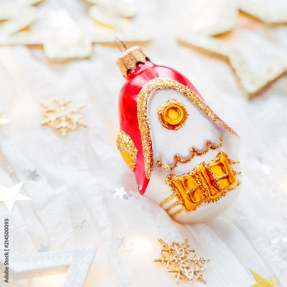 Christmas and New Year holiday background with decorations and light bulbs. Golden shining ball and house, snowflakes and star confetti. Christmas and New Year holiday background with decorations and light bulbs. Golden shining ball and house, snowflakes and star confetti.