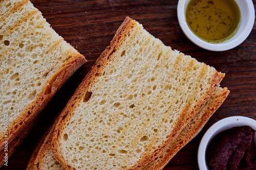 Gourmet Italian snack, restaurant menu ,food photo concept. Chef's olive tapenada and crunchy rye baguette in restaurant serving. photo