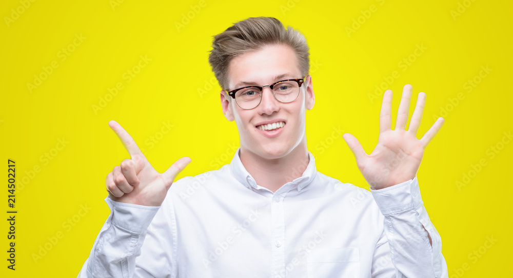 Young handsome blond man showing and pointing up with fingers number seven while smiling confident and happy. Young handsome blond man showing and pointing up with fingers number seven while smiling confident and happy.