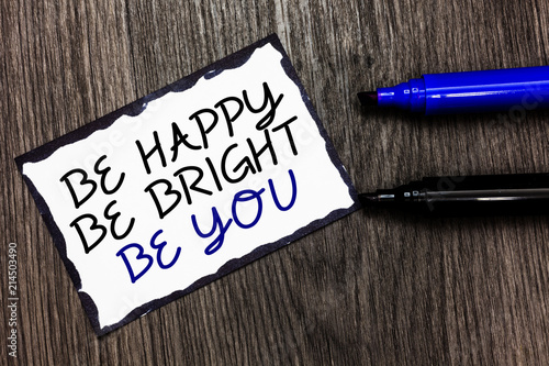 Word writing text Be Happy Be Bright Be You. Business concept for Self-confidence good attitude enjoy cheerful Black bordered page with texts laid black and blue pen on wooden floor.