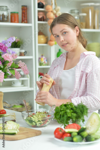 teen girl preparing fresh salad