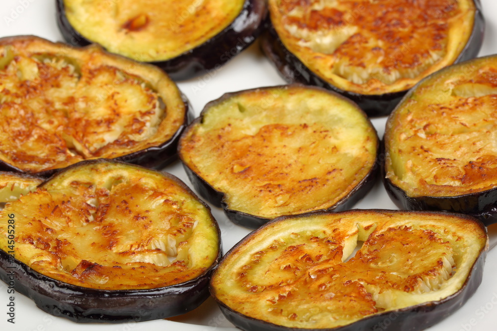 Sliced roasted eggplants in a white plate