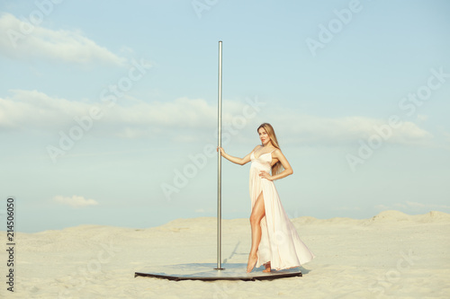 Beautiful young woman near a pylon.