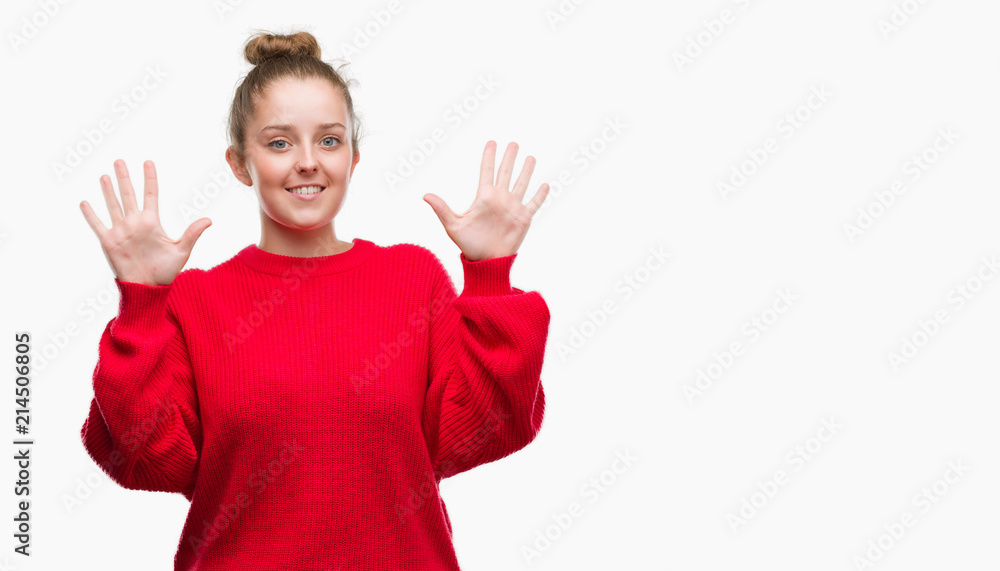Young blonde woman wearing bun and red sweater showing and pointing up with fingers number ten while smiling confident and happy. Young blonde woman wearing bun and red sweater showing and pointing up with fingers number ten while smiling confident and happy.