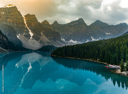 Sunrise with turquoise waters of the Moraine lake with sin lit rocky mountains in Banff National Park of Canada in Valley of the ten peaks.