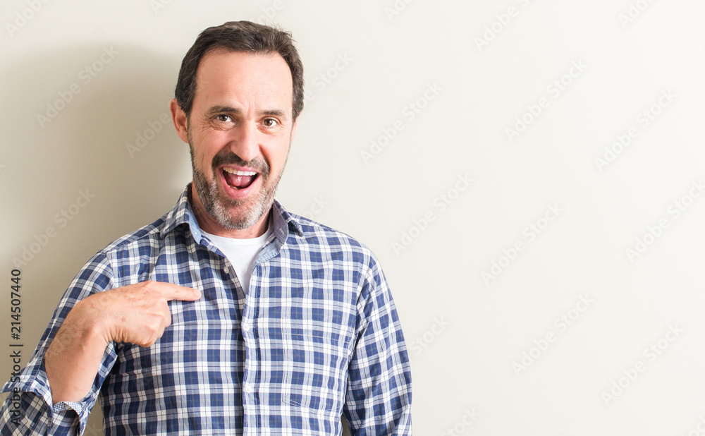 Senior man with surprise face pointing finger to himself Senior man with surprise face pointing finger to himself