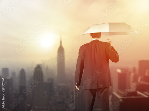Work life balance concept: Business man balancing above the city