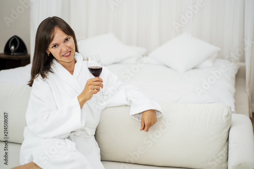 Young smiling woman on white sofa