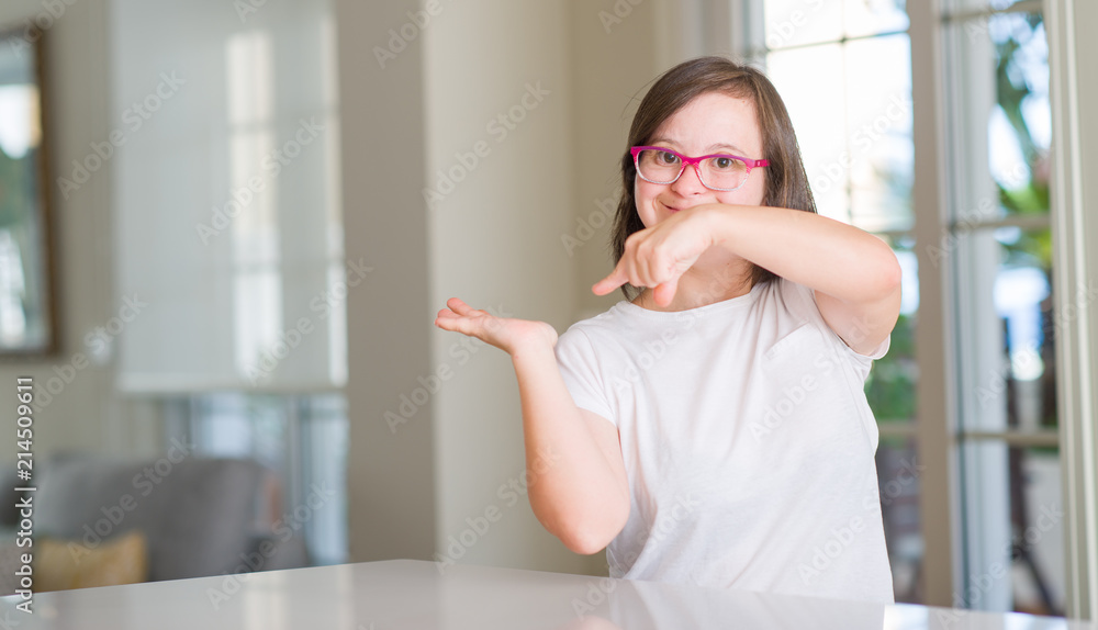 Down syndrome woman at home very happy pointing with hand and finger Down syndrome woman at home very happy pointing with hand and finger