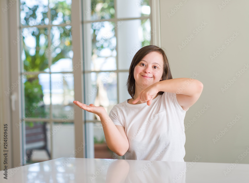Down syndrome woman at home very happy pointing with hand and finger Down syndrome woman at home very happy pointing with hand and finger