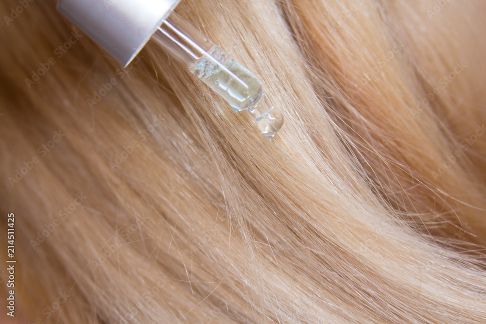 Fototapeta premium Beautiful Hair. background. Beauty Healthy blond Hair. shiny straight hair. Hairstyle. Hair cosmetics. Damage hair Health of hair