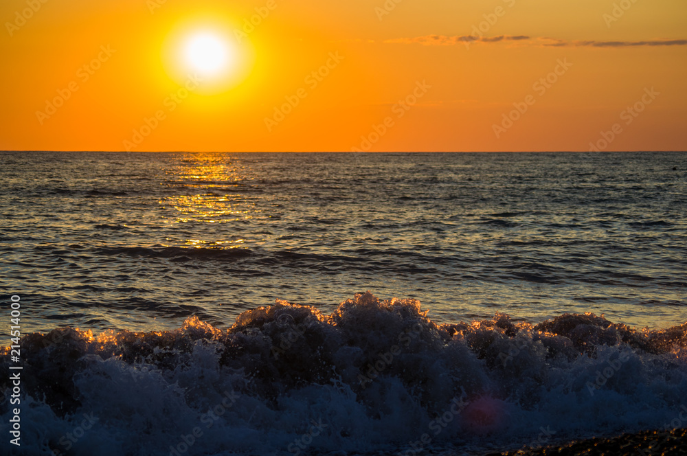Fototapeta premium Amazing sea sunset, the sun, waves, clouds