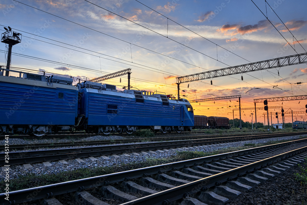 railroad infrastructure during beautiful sunset and colorful sky, trains and wagons, transportation and industrial concept