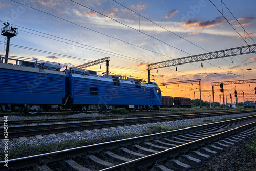 railroad infrastructure during beautiful sunset and colorful sky, trains and wagons, transportation and industrial concept © soleg