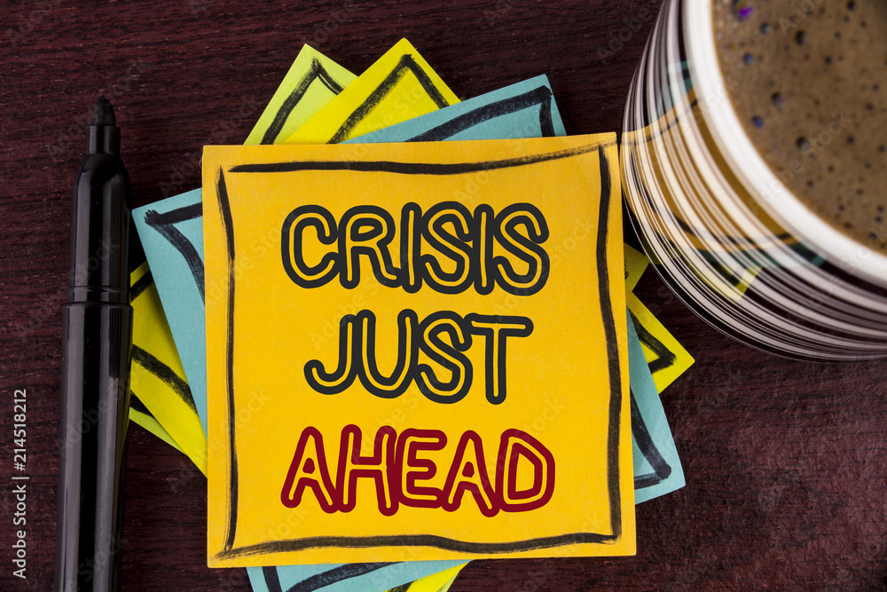 Writing note showing  Crisis Just Ahead. Business photo showcasing Foresee failure take right action before it is late written on Sticky Note paper on Wooden background Coffee Cup and Marker