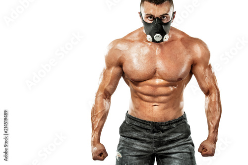 Brutal strong muscular bodybuilder athletic man pumping up muscles in training mask on white background. Workout bodybuilding concept. Copy space for sport nutrition ads.