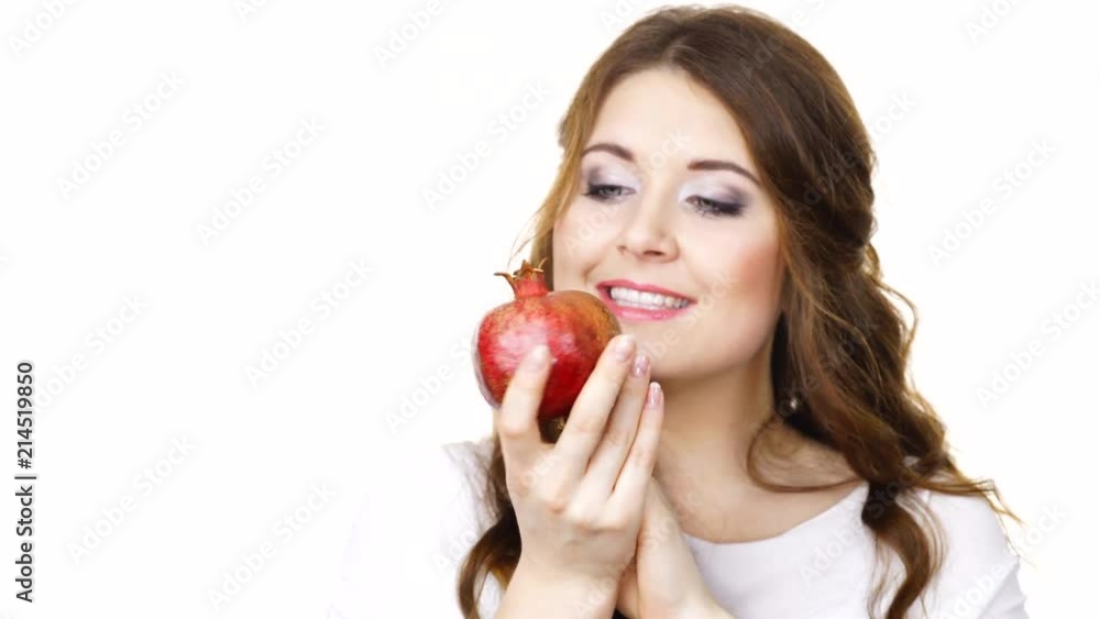 Joyful young woman playing with pomegranate fruit, isolated on white. Healthy eating, cancer prevention, immune support concept. Joyful young woman playing with pomegranate fruit, isolated on white. Healthy eating, cancer prevention, immune support concept.