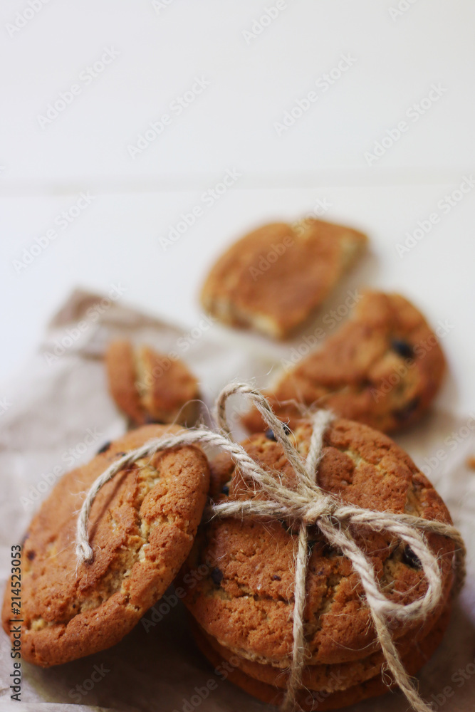 oat cookies with chocolate and bow on craft paper and light background