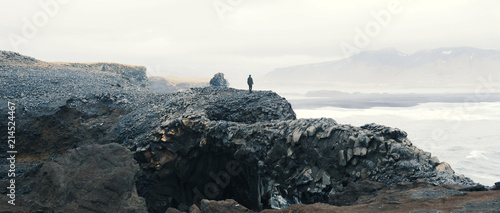 Woman overlooking scene at Vik, Iceland.