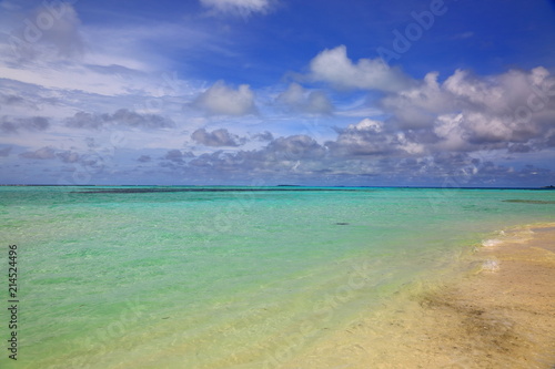 Beautiful view of white sand beach. Turquoise water and blue sky with white clouds. Indian Ocean, Maldives.