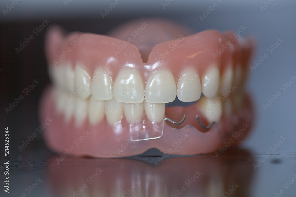 Set of medical denture on dark table Set of medical denture on dark table
