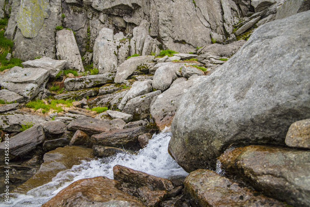 Mountain river on a background of gray mountain stones Mountain river on a background of gray mountain stones