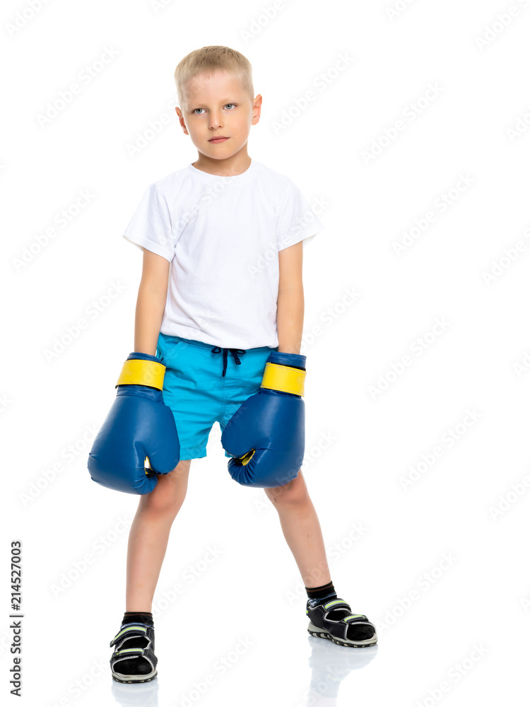 A little boy in a clean white T-shirt and boxing gloves. A little boy in a clean white T-shirt and boxing gloves.