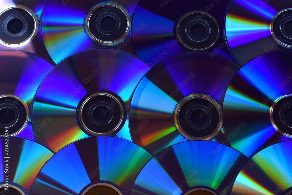 Fondo de discos de DVD y CDs iluminados. Fondo de discos de DVD y CDs iluminados.