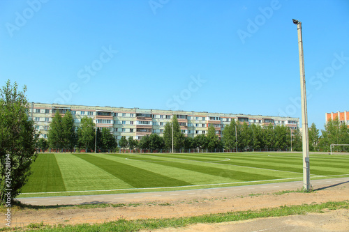 Artificial football field. School stadium in the city.