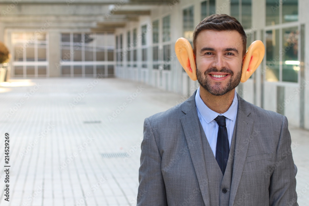 Big-eared businessman smiling in office space Big-eared businessman smiling in office space