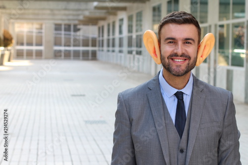Canvas Print Man using hearing aid in the office